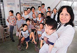 260px-A_vietnamese_Professor_is_pictured_with_a_group_of_handicapped_children